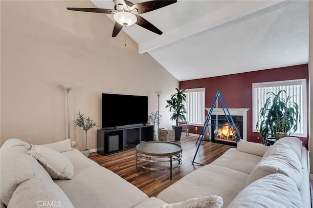 13329 Mission Tierra Way, Granada Hills, CA 91344 - living room with wood finished floors, beamed ceiling, a ceiling fan, high vaulted ceiling, and a warm lit fireplace