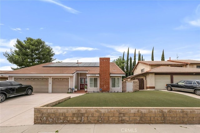 13329 Mission Tierra Way, Granada Hills, CA 91344 - view of front of property featuring a garage, solar panels, and concrete driveway