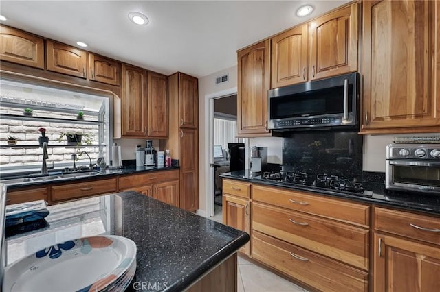 13329 Mission Tierra Way, Granada Hills, CA 91344 - kitchen featuring stainless steel microwave, black gas cooktop, backsplash, dark stone counters, and recessed lighting