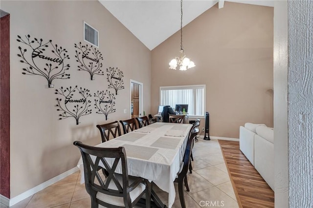 13329 Mission Tierra Way, Granada Hills, CA 91344 - dining space featuring light tile patterned floors, high vaulted ceiling, and a chandelier