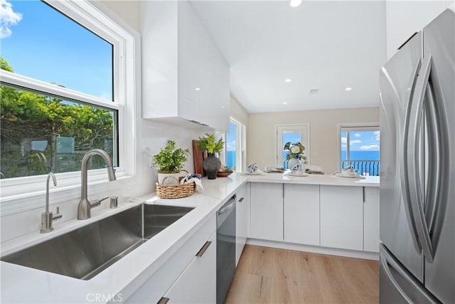 2961 Rounsevel, Laguna Beach, CA 92651 - kitchen with appliances with stainless steel finishes, white cabinetry, modern cabinets, light wood-style floors, and recessed lighting