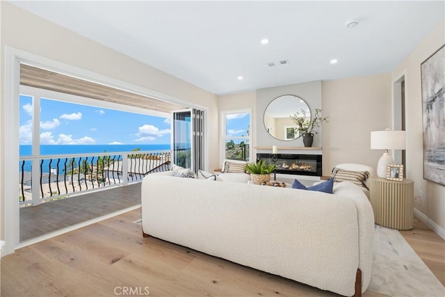 2961 Rounsevel, Laguna Beach, CA 92651 - living area with light wood-style flooring, a glass covered fireplace, a water view, and recessed lighting