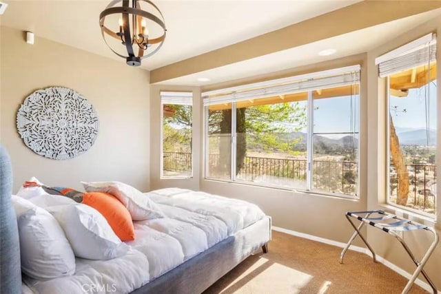 8075 Quail Trl, Yucca Valley, CA 92284 - carpeted bedroom featuring a chandelier and baseboards