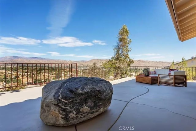 8075 Quail Trl, Yucca Valley, CA 92284 - view of patio featuring an outdoor hangout area and a mountain view
