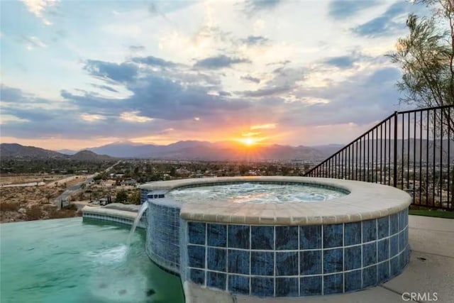 8075 Quail Trl, Yucca Valley, CA 92284 - pool at dusk featuring an in-ground hot tub and a mountain view