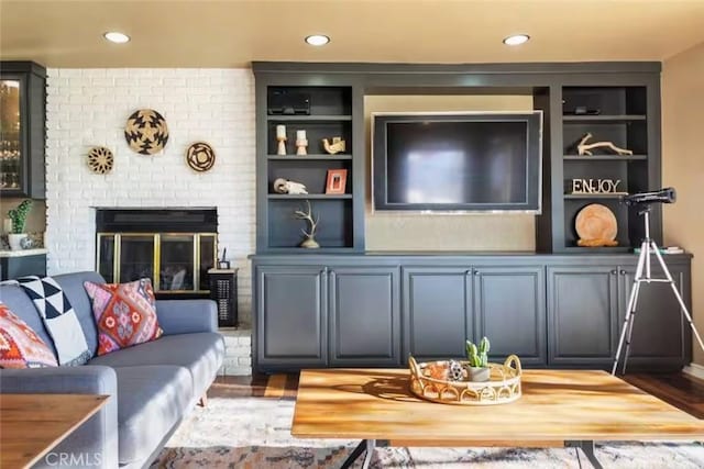 8075 Quail Trl, Yucca Valley, CA 92284 - living area featuring wood finished floors, recessed lighting, a brick fireplace, and built in features