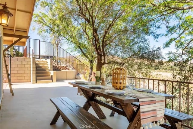 8075 Quail Trl, Yucca Valley, CA 92284 - deck with outdoor dining space, a patio area, and stairway