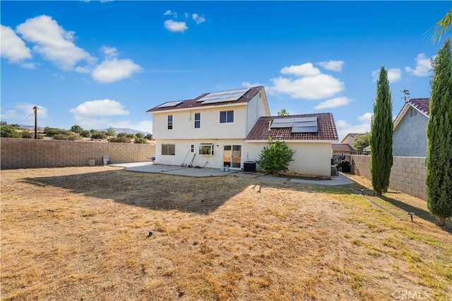 37338 Salem Ct, Palmdale, CA 93550 - back of house with a patio, roof mounted solar panels, a fenced backyard, and stucco siding