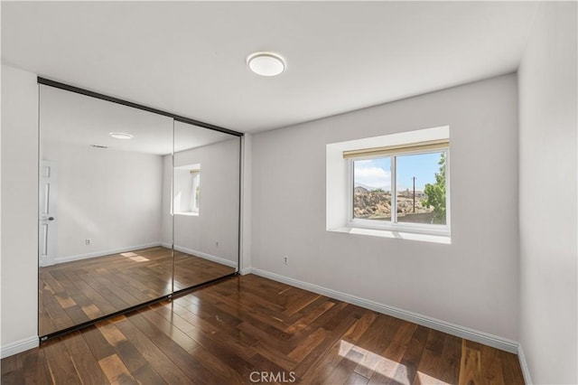 37338 Salem Ct, Palmdale, CA 93550 - unfurnished bedroom featuring multiple windows, hardwood / wood-style flooring, and a closet
