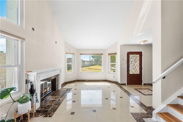 37338 Salem Ct, Palmdale, CA 93550 - foyer entrance featuring inlaid floor details, plenty of natural light, high vaulted ceiling, stairway, and a high end fireplace
