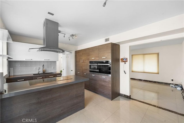 37338 Salem Ct, Palmdale, CA 93550 - kitchen with dark countertops, island exhaust hood, oven, and backsplash