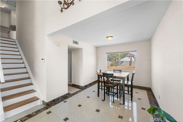 37338 Salem Ct, Palmdale, CA 93550 - tiled dining space featuring stairs and inlaid floor details