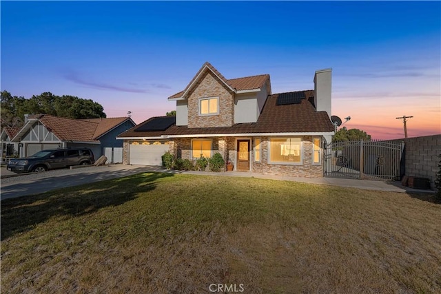 37338 Salem Ct, Palmdale, CA 93550 - view of front of house featuring stone siding, solar panels, and concrete driveway