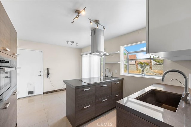 37338 Salem Ct, Palmdale, CA 93550 - kitchen featuring island exhaust hood, black electric cooktop, dark brown cabinetry, a peninsula, and modern cabinets