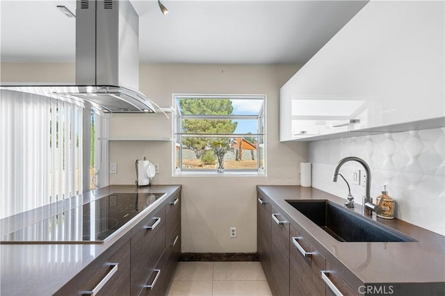 37338 Salem Ct, Palmdale, CA 93550 - kitchen with island range hood, dark brown cabinets, light tile patterned floors, and black electric stovetop