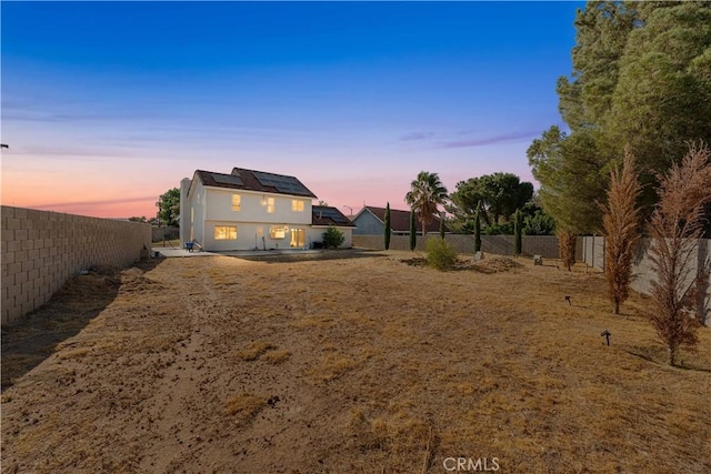 37338 Salem Ct, Palmdale, CA 93550 - yard at dusk with a fenced backyard and a patio area