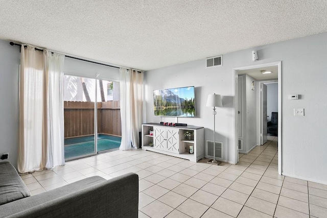 2521 W Sunflower Ave Unit R1, Santa Ana, CA 92704 - unfurnished living room featuring light tile patterned floors and a textured ceiling