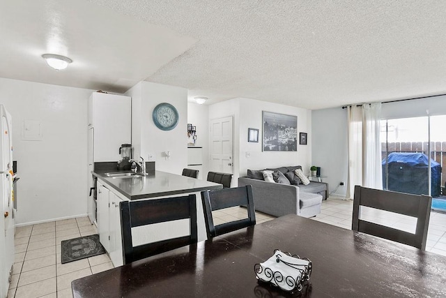 2521 W Sunflower Ave Unit R1, Santa Ana, CA 92704 - dining space with a textured ceiling and light tile patterned flooring