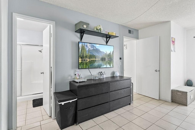 2521 W Sunflower Ave Unit R1, Santa Ana, CA 92704 - full bathroom with tile patterned flooring, a textured ceiling, and a stall shower