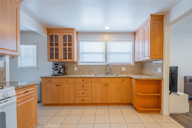10404 Jardine Ave, Sunland, CA 91040 - kitchen with decorative backsplash, glass insert cabinets, electric stove, and light stone counters