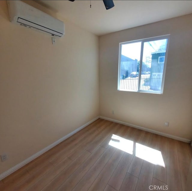 3765 Globe Ave, Los Angeles, CA 90066 - unfurnished room with a wall mounted AC, wood finished floors, and a ceiling fan