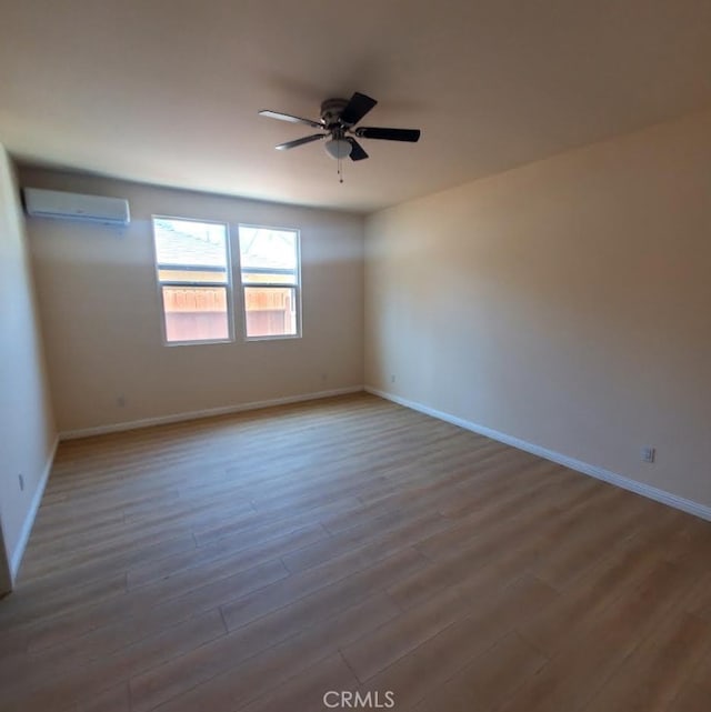 3765 Globe Ave, Los Angeles, CA 90066 - empty room featuring wood finished floors, ceiling fan, and a wall mounted air conditioner