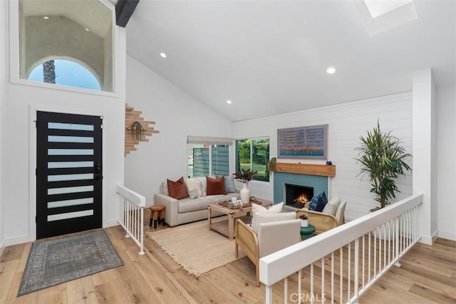 32772 Shipside Dr, Dana Point, CA 92629 - living room with hardwood / wood-style flooring, high vaulted ceiling, a lit fireplace, a skylight, and recessed lighting