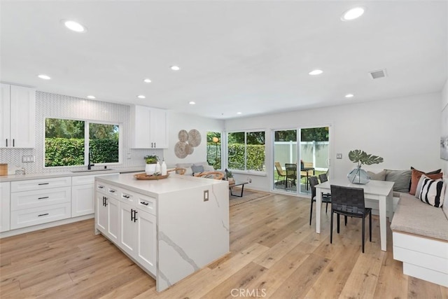 32772 Shipside Dr, Dana Point, CA 92629 - kitchen with recessed lighting, decorative backsplash, light wood finished floors, and white cabinetry