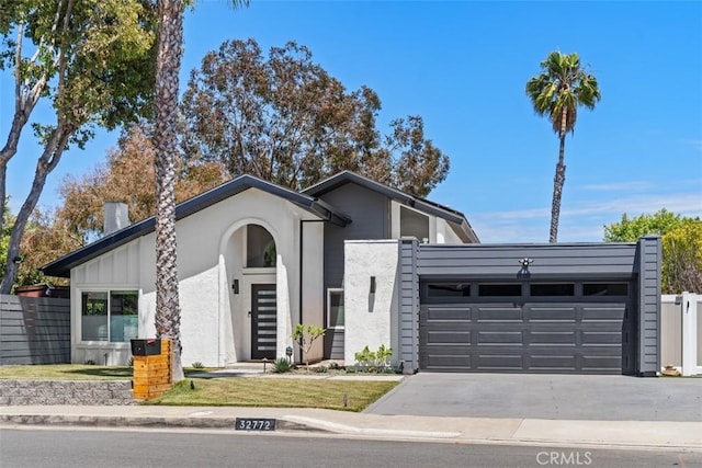 32772 Shipside Dr, Dana Point, CA 92629 - mid-century inspired home featuring a garage, driveway, and stucco siding