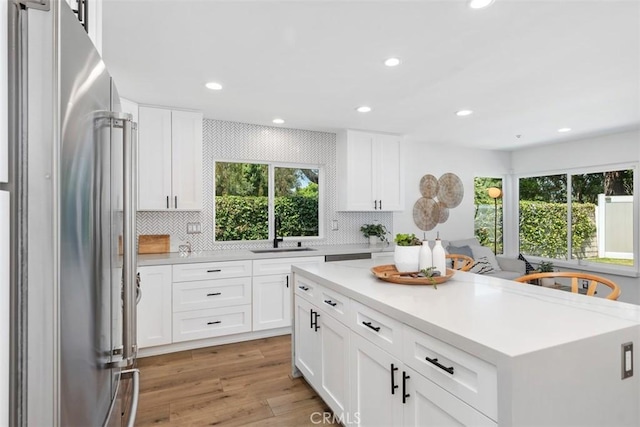32772 Shipside Dr, Dana Point, CA 92629 - kitchen featuring high end fridge, light countertops, decorative backsplash, recessed lighting, and light wood-type flooring