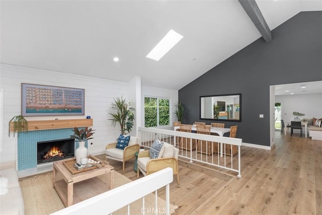 32772 Shipside Dr, Dana Point, CA 92629 - living room featuring high vaulted ceiling, wood finished floors, a skylight, a tile fireplace, and recessed lighting