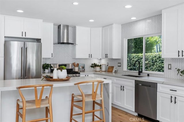 32772 Shipside Dr, Dana Point, CA 92629 - kitchen with wall chimney range hood, stainless steel appliances, a kitchen island, white cabinets, and backsplash