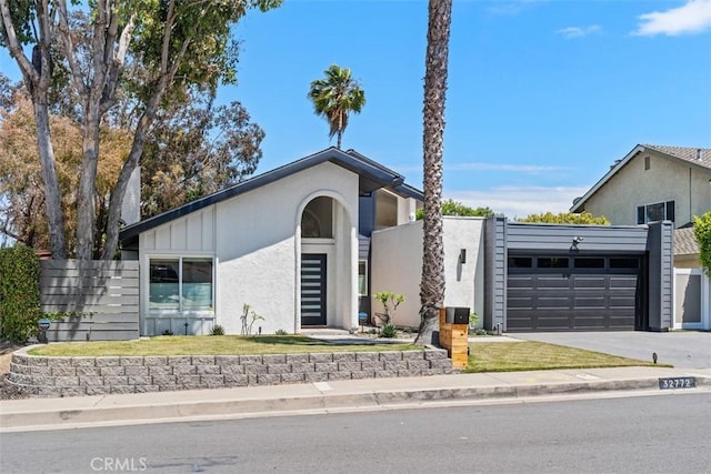 32772 Shipside Dr, Dana Point, CA 92629 - mid-century inspired home featuring an attached garage, driveway, and stucco siding