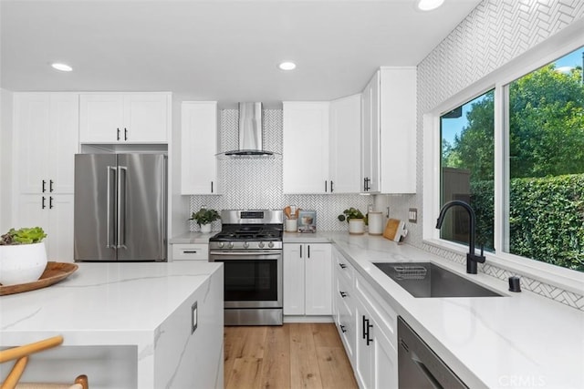 32772 Shipside Dr, Dana Point, CA 92629 - kitchen featuring appliances with stainless steel finishes, wall chimney exhaust hood, tasteful backsplash, white cabinetry, and light stone countertops