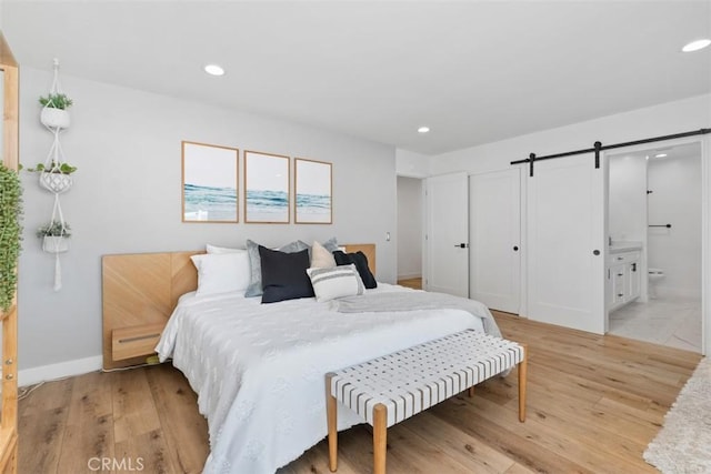 32772 Shipside Dr, Dana Point, CA 92629 - bedroom featuring a barn door, recessed lighting, light wood-style flooring, and ensuite bath