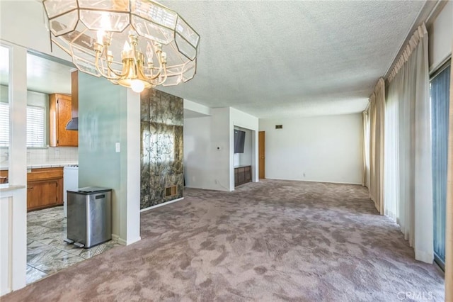 1908 W 134th Pl, Gardena, CA 90249 - unfurnished dining area with a chandelier, light carpet, and a textured ceiling