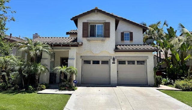 2552 Saddlehorn Dr, Chula Vista, CA 91914 - mediterranean / spanish house featuring driveway, a tiled roof, a garage, and stucco siding