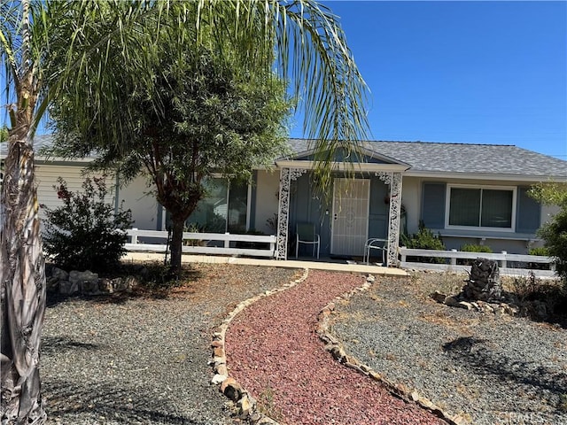 27102 Capilano Dr, Menifee, CA 92586 - view of front of home featuring a porch, stucco siding, and roof with shingles
