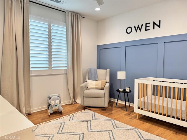 28524 Songbird Way, Saugus, CA 91350 - bedroom featuring a nursery area, wood finished floors, a ceiling fan, recessed lighting, and multiple windows