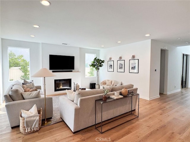 28524 Songbird Way, Saugus, CA 91350 - living area featuring recessed lighting, light wood-type flooring, and a glass covered fireplace