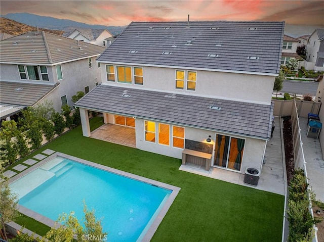 28524 Songbird Way, Saugus, CA 91350 - back of house at dusk featuring stucco siding, a patio area, a fenced backyard, an outdoor pool, and an outdoor fire pit