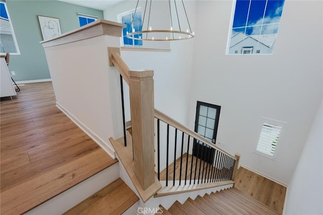 28524 Songbird Way, Saugus, CA 91350 - staircase featuring a chandelier, wood finished floors, and a high ceiling