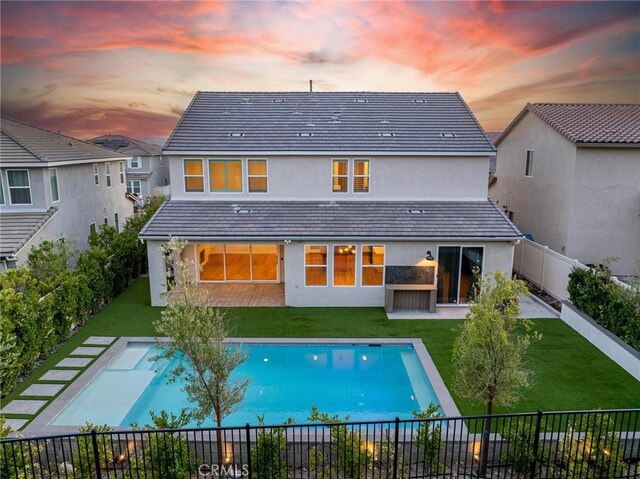 28524 Songbird Way, Saugus, CA 91350 - back of house at dusk featuring stucco siding and a fenced backyard