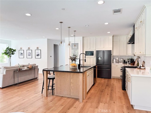 28524 Songbird Way, Saugus, CA 91350 - kitchen with high end fridge, built in microwave, open floor plan, gas range oven, and light wood-style floors