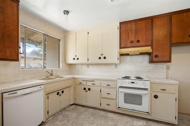 2729 N Studebaker Rd, Long Beach, CA 90815 - kitchen with white appliances, under cabinet range hood, decorative backsplash, and light countertops