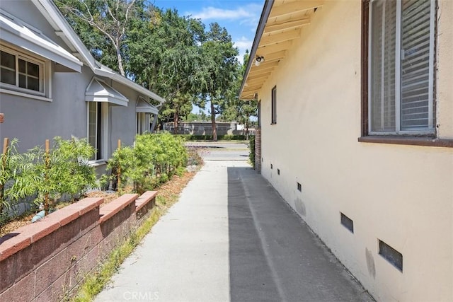 2729 N Studebaker Rd, Long Beach, CA 90815 - view of side of property featuring stucco siding and crawl space