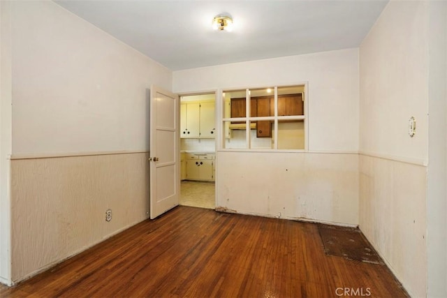 2729 N Studebaker Rd, Long Beach, CA 90815 - empty room featuring wood finished floors and a wainscoted wall