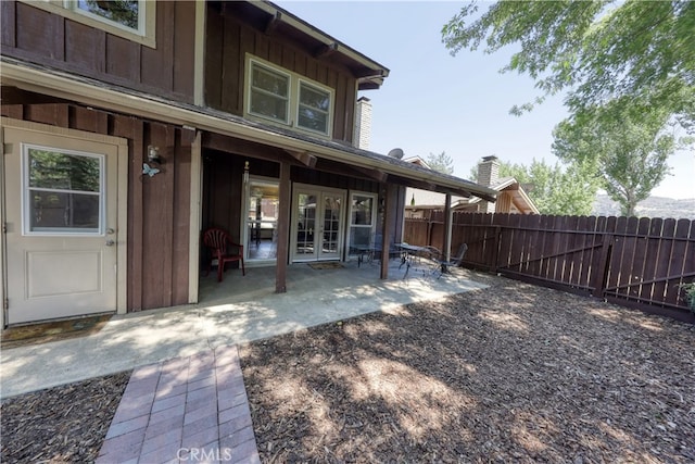 77 Meadow Lakes Dr, Tehachapi, CA 93561 - back of house with french doors, a patio area, and board and batten siding