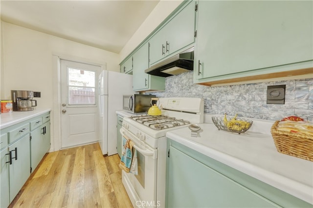 77 Meadow Lakes Dr, Tehachapi, CA 93561 - kitchen with gas range gas stove, under cabinet range hood, stainless steel microwave, light wood-type flooring, and green cabinets
