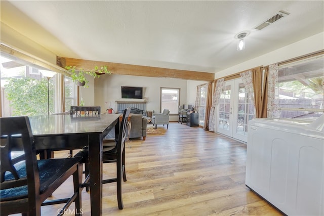 77 Meadow Lakes Dr, Tehachapi, CA 93561 - dining space with washer / dryer, light wood-style flooring, french doors, and a brick fireplace
